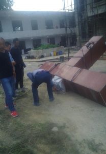 Men dismantling a cross