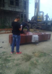 Men dismantling a cross