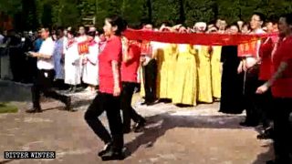 Le squadre delle varie regioni eseguono la cerimonia dell’alzabandiera di fronte alla chiesa prima delle gare